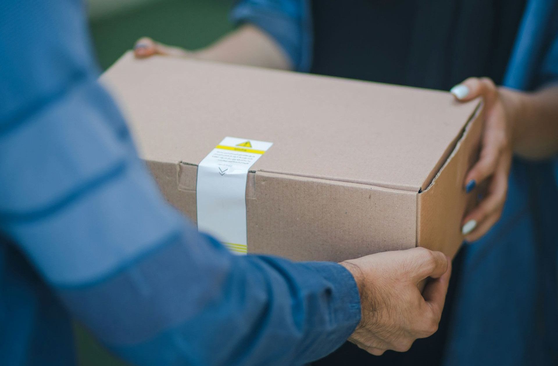 person giving brown box