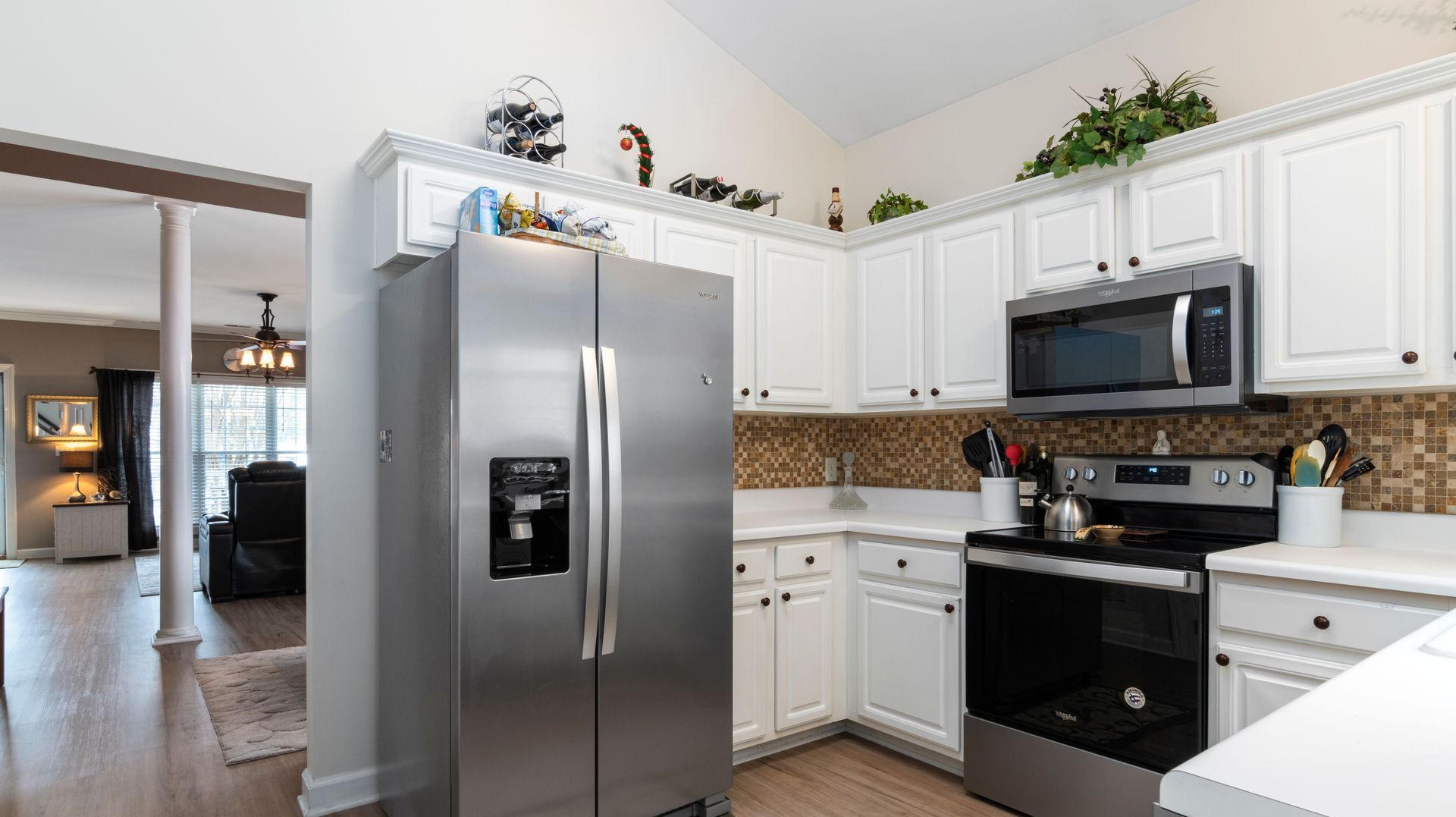 Bright kitchen showcasing stainless steel appliances and white cabinets.